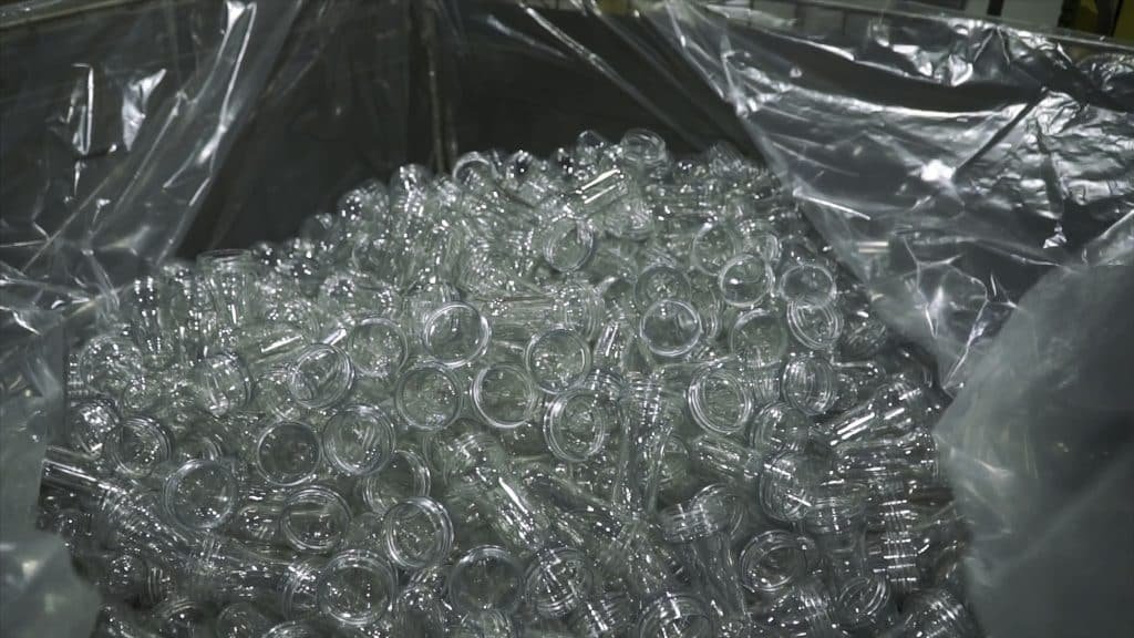 First person view on Bottle. Clip. Industrial production of plastic pet bottles. Rows of empty