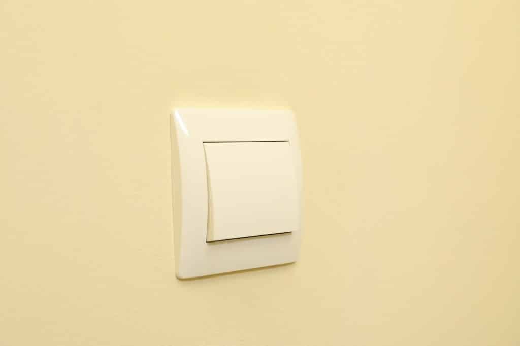 On-Off light switch on the beige wall