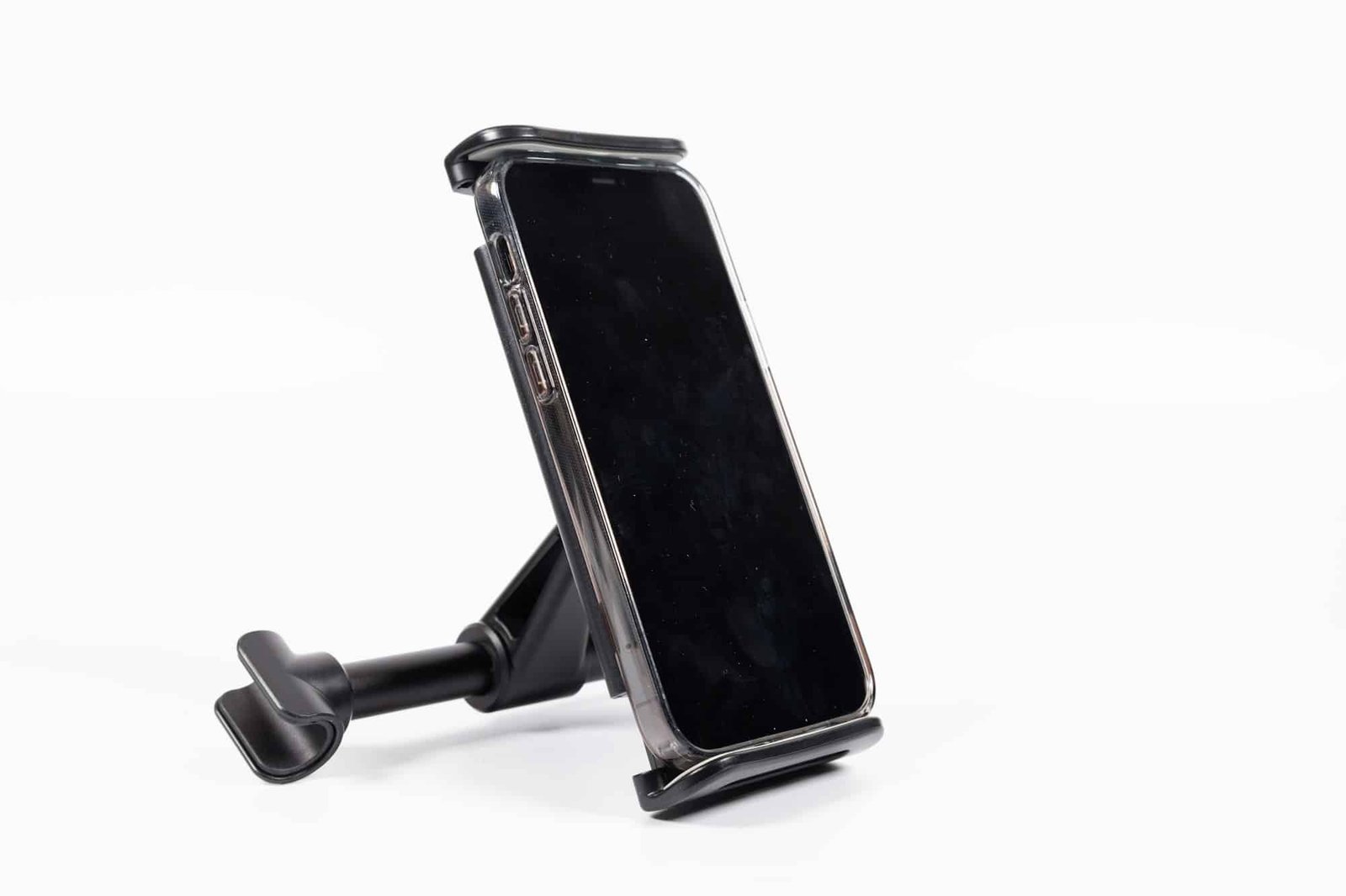 Isolated shot of a mobile phone in a car phone holder on a white background